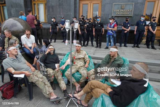 Protesters sit outside the presidential office during the strike. Volunteer fighters of Donbas volunteering battalion went on a hunger strike 19 days...