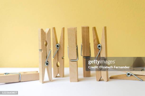 clothespins on yellow background - clothing isolated photos et images de collection