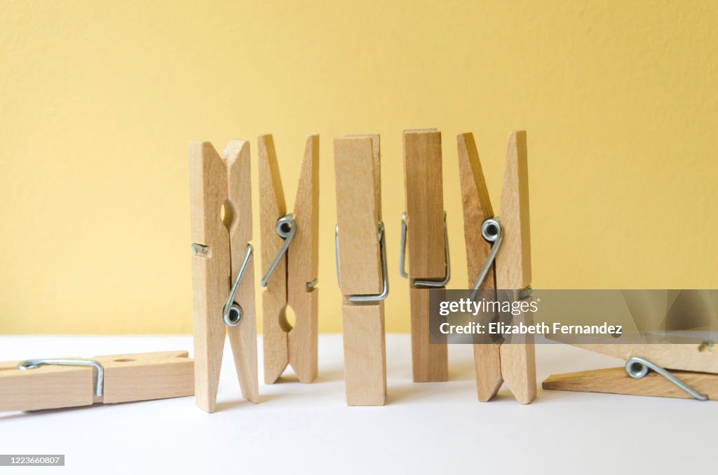 Clothespins on yellow background