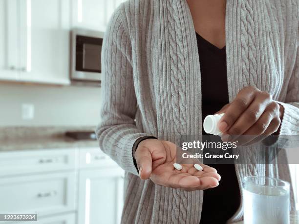 woman takes medication - antidepressants stockfoto's en -beelden