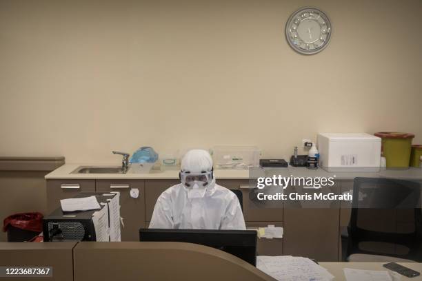 Medical worker dressed in personal protective equipment works at a computer inside the COVID-19 ICU at the Kartal Dr. Lutii Kirdar Education and...