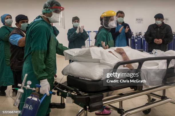 Medical staff clap and cheer as a COVID-19 patient is discharged from the Kartal Dr. Lutii Kirdar Education and Research Hospital, Intensive Care...