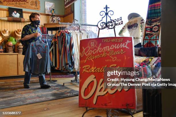 Steve Weil, owner of Rockmount Ranch Wear, prepares for the reopening of the store in downtown Denver, Colorado on Friday. May 8, 2020.