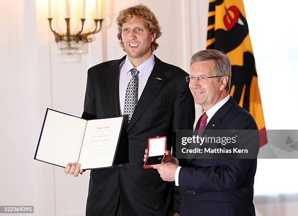 German President Christian Wulff honors Dirk Nowitzki with the 'Silbernes Lorbeerblatt' during a ceremony at the presidential Bellevue palace in...