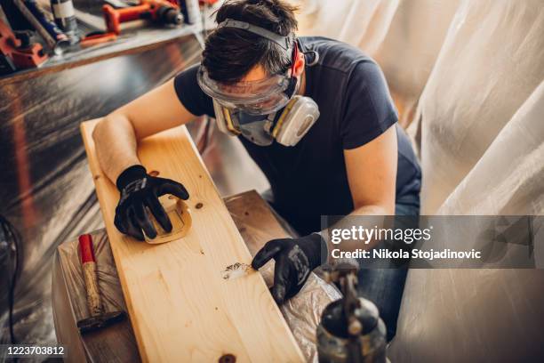 bearded craftsman wrapped up in work - cleaning sawdust stock pictures, royalty-free photos & images