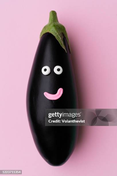 happy eggplant vegetable with face on pink background - anthropomorphic face stock pictures, royalty-free photos & images