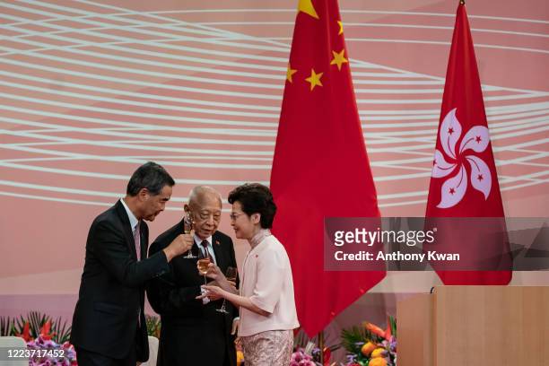 Hong Kong's Chief Executive Carrie Lam makes a toast with former chief executives Tung Chee-hwa and Leung Chun-ying during a reception following a...