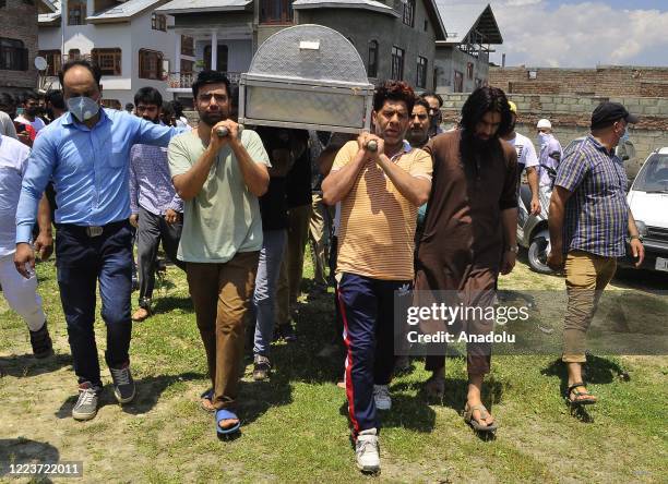 People carry the coffin containing the dead body of a civilian Bashir Ahmad in HMT Srinagar, Kashmir on July 01, 2020. One Indian soldier and a...