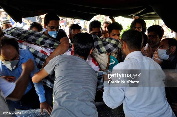 People carry the dead body of a civilian Bashir Ahmad for last rites at the residence in HMT Srinagar, Kashmir on July 01, 2020.One Indian soldier...