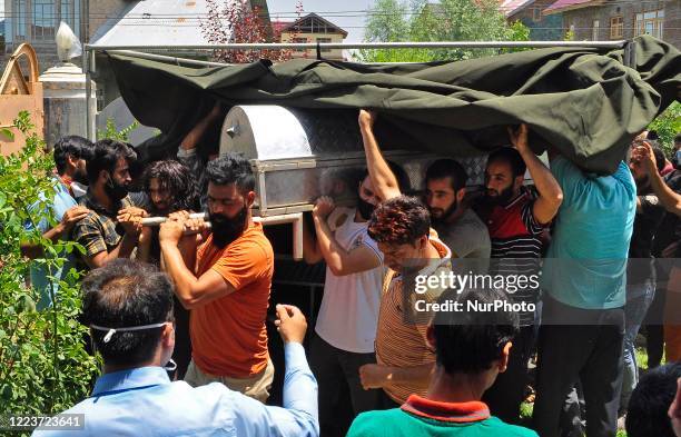 People carry the coffin containing the dead body of a civilian Bashir Ahmad in HMT Srinagar, Kashmir on July 01, 2020.One Indian soldier and a...