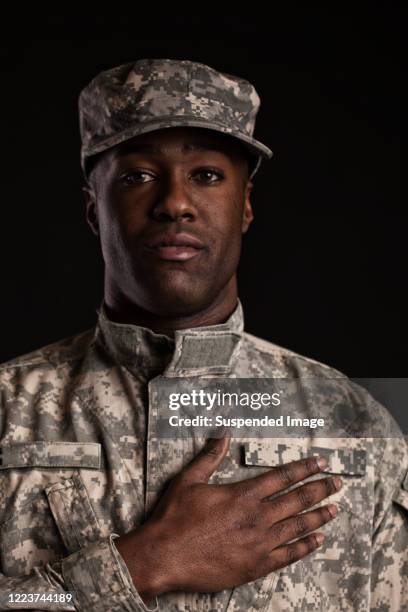 black soldier in uniform with hand on heart - hand on heart stock pictures, royalty-free photos & images