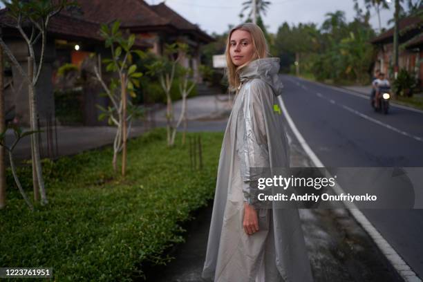 beautiful young woman in raincoat - raincoat ストックフォトと画像