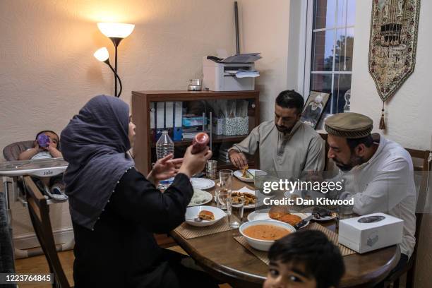 Imam Raza Ahmed, his brother Rizwan, wife Anam and two sons Daniel and Daud take iftar, the fast-breaking meal after sunset at their family home on...