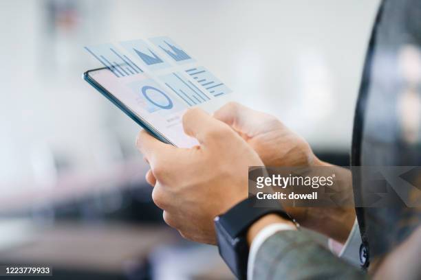 businessman using virtual visual screen - augmented reality phone stock-fotos und bilder