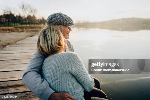 senior couple on a lake dock - couple jetty stock pictures, royalty-free photos & images