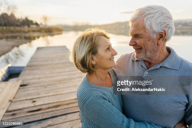 enjoying together by the lake - baby boomer stock pictures, royalty-free photos & images