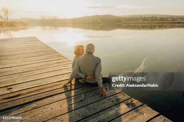 enjoying together by the lake - jetty stock pictures, royalty-free photos & images