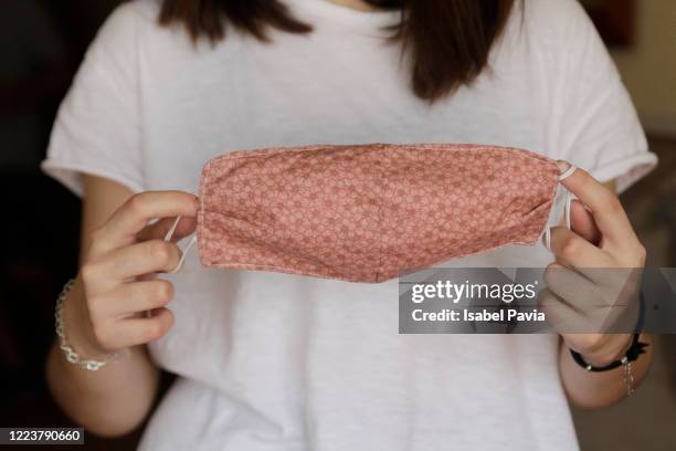 woman holding homemade face mask - cloth mask 個照片及圖片檔