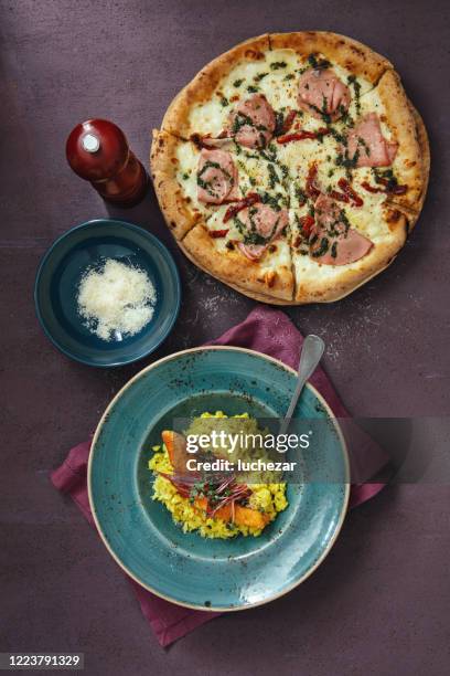 grilled salmon with lemon risotto and italian pizza with mortadella - risotto stock pictures, royalty-free photos & images