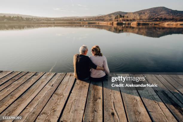 enjoying together by the lake - pier imagens e fotografias de stock