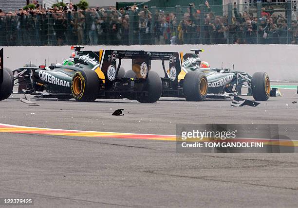 Team Lotus' Finnish driver Heikki Kovalainen and Team Lotus' Italian driver Jarno Trulli avoid debris after a crash by ScuderiaToro Rosso's Spanish...