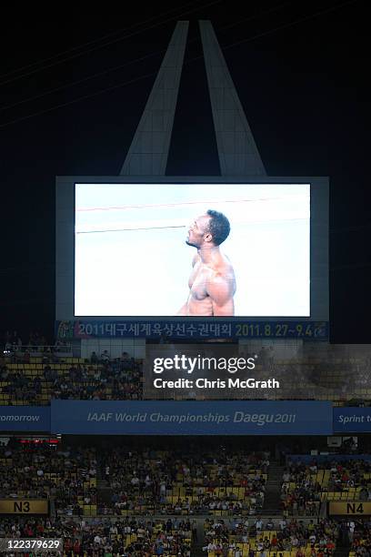 Usain Bolt of Jamaica is displayed on one of the stadium's big screens after being disqualified for a false start in the Men's 100 metre final during...