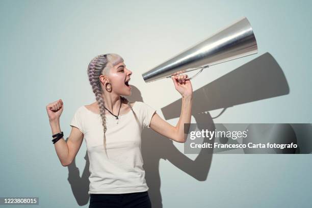 woman using a megaphone - teen shouting stock pictures, royalty-free photos & images