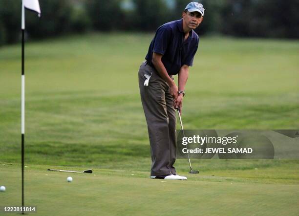 President Barack Obama reacts after plays a shot at the 10th green at the Grove Park Inn in Asheville, North Carolina, on April 23, 2010. The First...