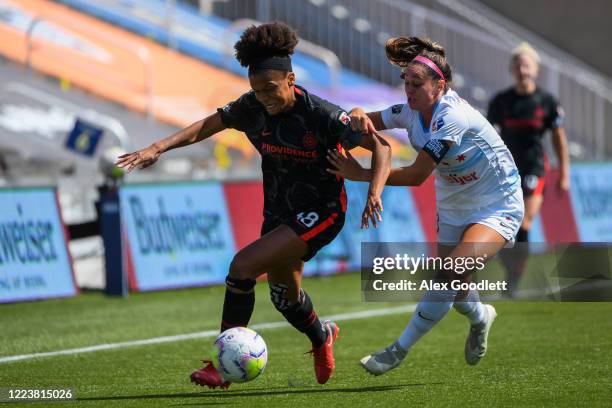 Simone Charley of Portland Thorns FC fights for the ball with Julia Bingham of Chicago Red Stars during a game in the first round of the NWSL...