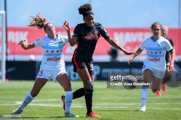 Simone Charley of Portland Thorns FC fights for the ball with Julia Bingham of Chicago Red Stars during a game in the first round of the NWSL...