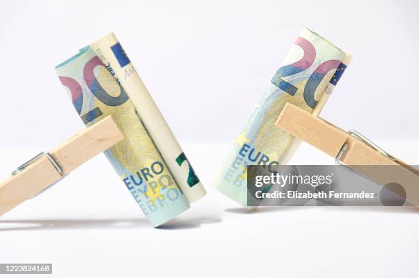 close-up of euro bank notes in a clothes peg - clothes peg isolated stock pictures, royalty-free photos & images