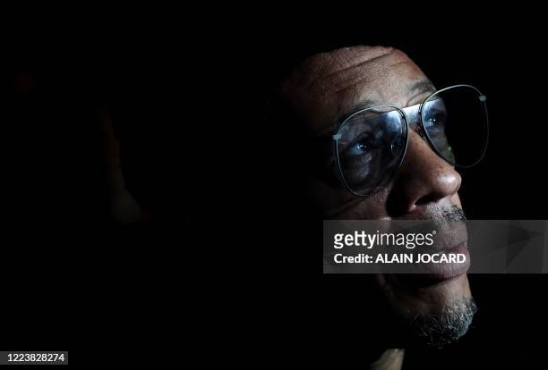 French rapper and actor Didier Morville, aka Joey Starr, reacts as he speaks to the press upon his arrival at the Balrock bar in Paris, on July 1...