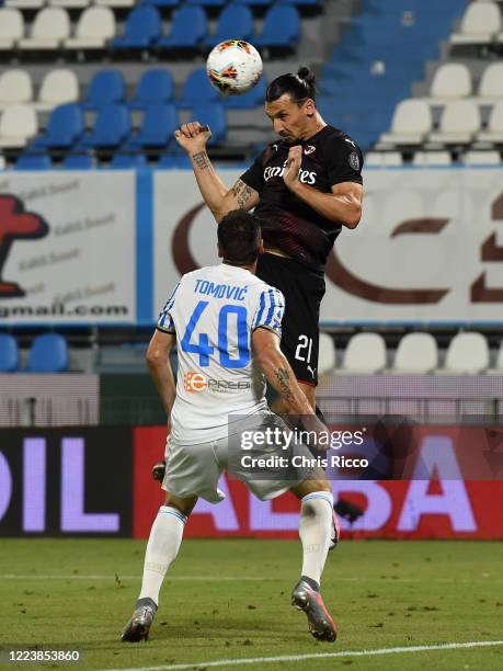 Zlatan Ibrahimovic of AC Milan gets above Nenad Tomovic of SPAL during the Serie A match between SPAL and AC Milan at Stadio Paolo Mazza on July 1,...