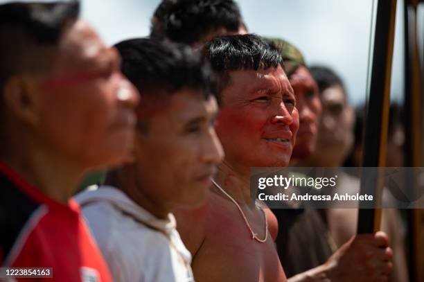 Yanomami indigenous look on as arriving to receive health care during the Yanomami / Raposa Serra do Sol Mission amidst at the coronavirus pandemic...