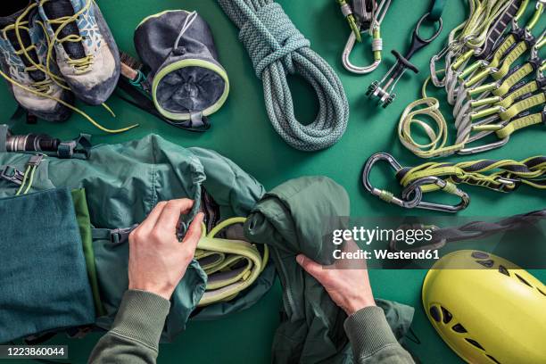 overhead view of man packing climbing utensils - device stock-fotos und bilder