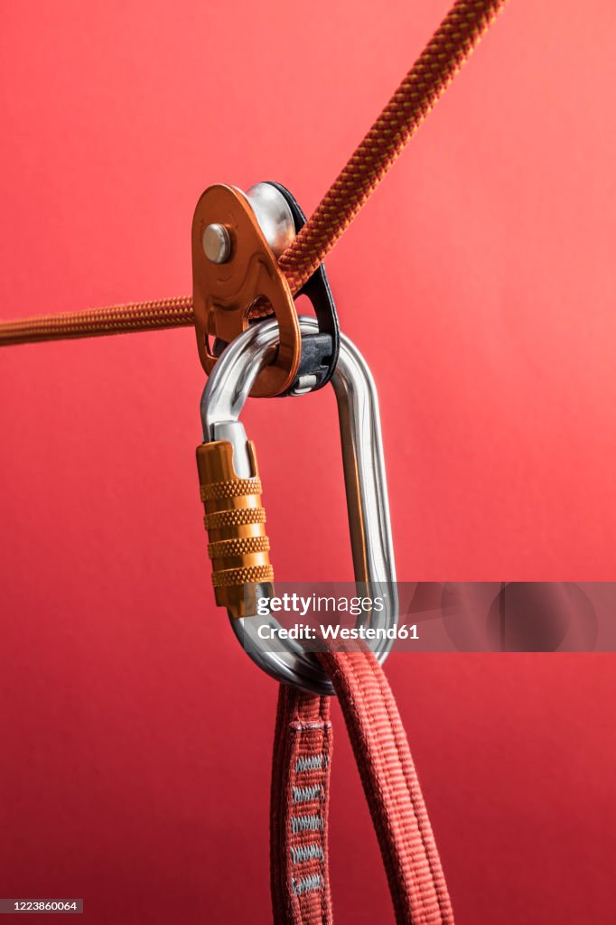 Climbing carabiner on harness loop and rope through pulley