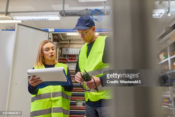 two electricians discussing plan - electrical switchboard stock pictures, royalty-free photos & images