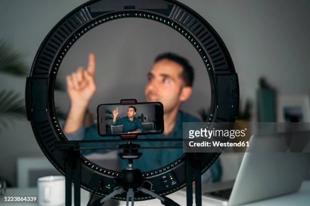 vlogger filming with smartpone at home - influencer fotografías e imágenes de stock