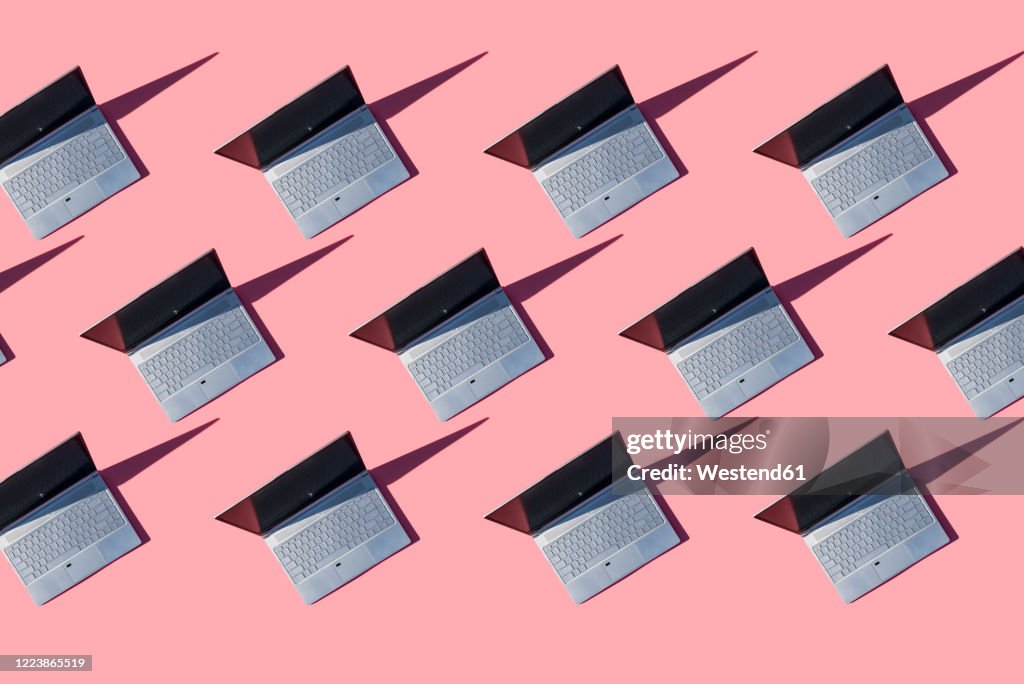 Laptops on pink background