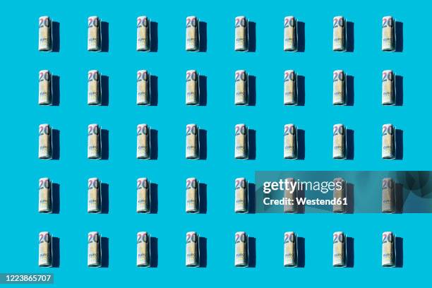 twenty euro rolled banknotes pattern on a blue background - twenty euro note bildbanksfoton och bilder