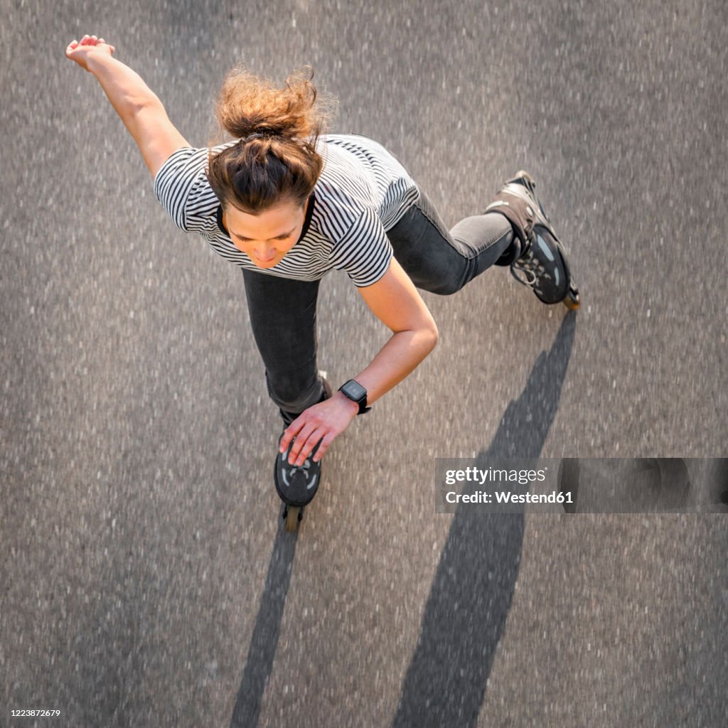 High angle view of woman inline skating on road during summer
