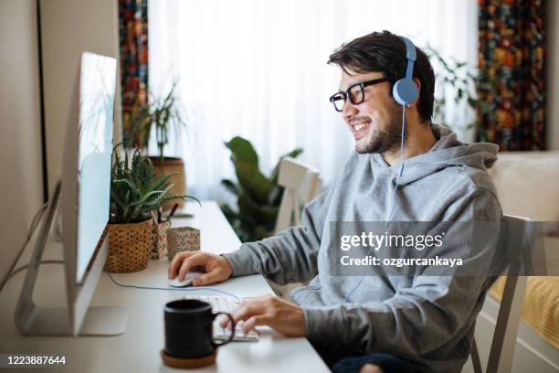 young men working from home - bet stock pictures, royalty-free photos & images