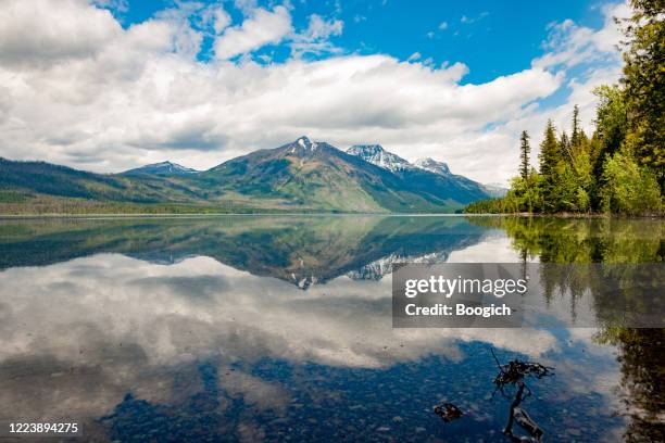 scenic lake mcdonald reflecting montana mountain - going to the sun road stock pictures, royalty-free photos & images