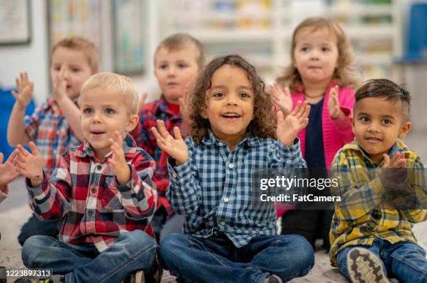 daycare students in the classroom - kids clapping class stock pictures, royalty-free photos & images