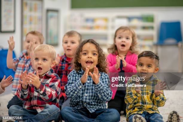 daycare students in the classroom - kids clapping class stock pictures, royalty-free photos & images