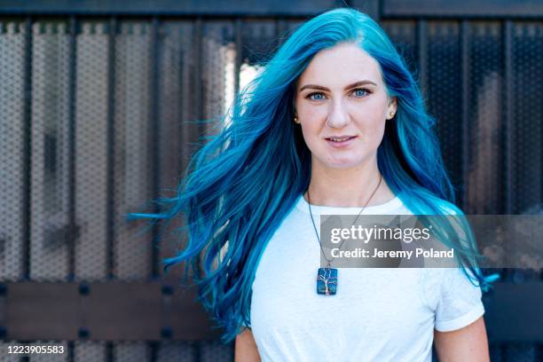 artsy portrait of unique spunky fashionable young woman with fun cute teal blue green dyed hair standing posing outdoors in the summer - blue hair stock pictures, royalty-free photos & images