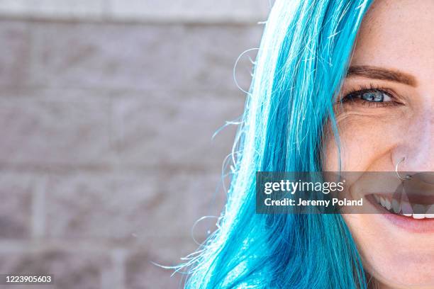 close-up shot of beautiful, unique, spunky, fashionable, young woman's blue eyes with fun cute teal blue-green dyed hair outdoors in the summer - blue hair stock pictures, royalty-free photos & images