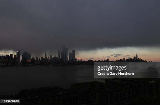 Snow squall passes over midtown Manhattan as the sun sets in New York City on May 9, 2020 as seen from Weehawken, New Jersey.
