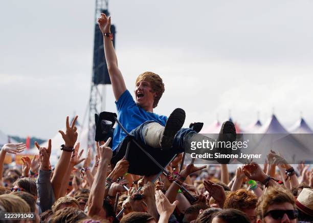 Music fan crowd surfs on a camping chair as The View performs live on the Main Stage during day three of Reading Festival 2011 on August 28, 2011 in...