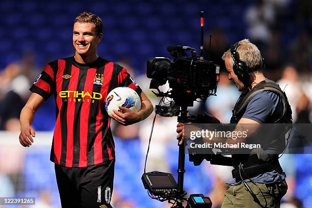 Edin Dzeko of Manchester City leaves the pitch with the matchball after scoring four goals after the Barclays Premier League match between Tottenham...